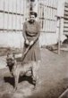 A. M. Schoss: portrét ženy se psem (černobílý negativ)